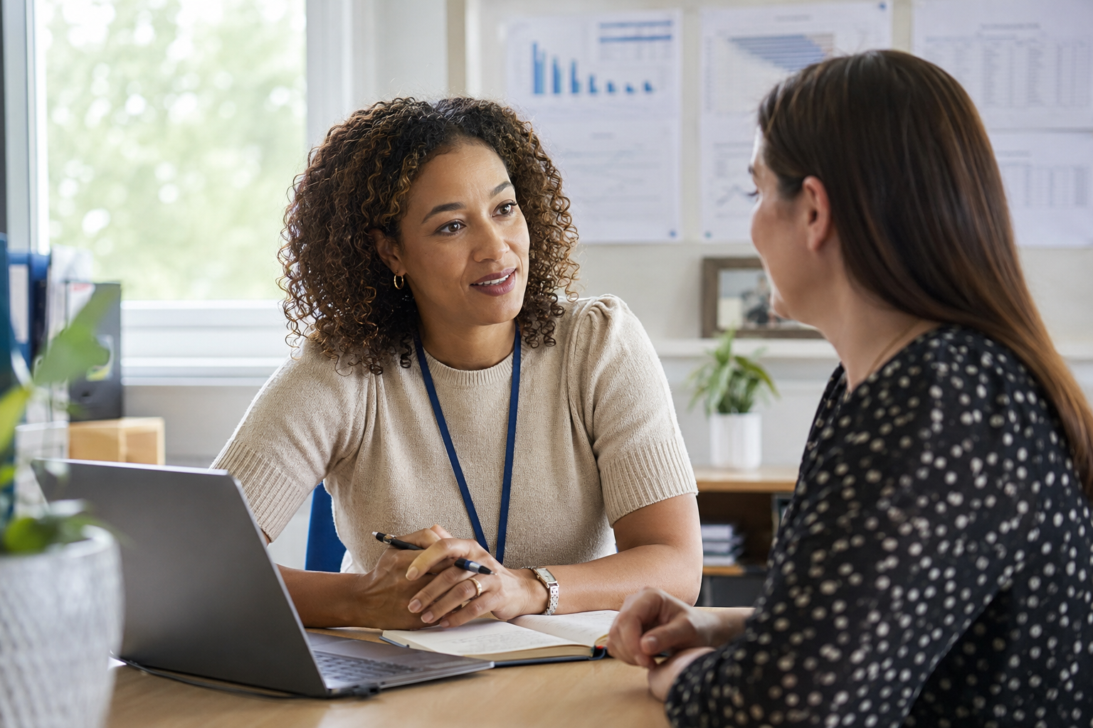 Two education professionals discussing development at a table
