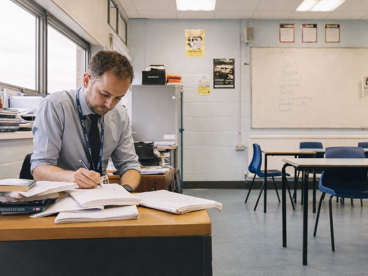 School business manager reviewing funding rules on a laptop